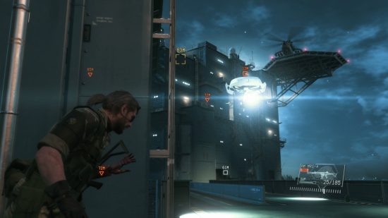 Best stealth games - Snake is hugging a wall near an oil drill in Metal Gear Solid 5.