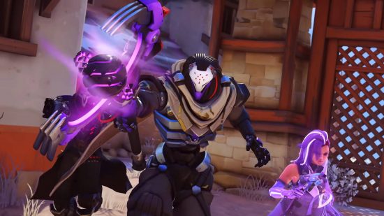 Best multiplayer games - Ramattra is using his cane to shoot energy blasts in Overwatch 2. Sombra and Reaper are running alongside him.
