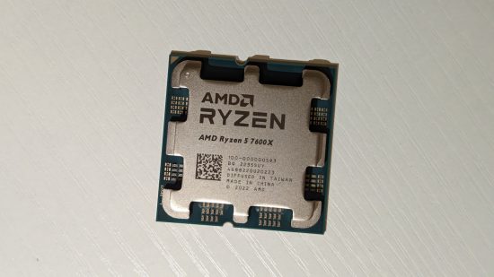 The AMD Ryzen 5 7600X processor resting atop a white wooden table