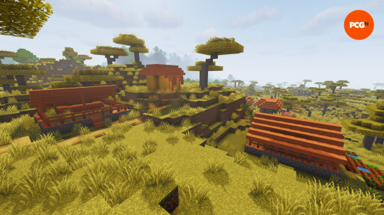An orange and yellow colored village in the middle of a savanna, one of the hottest Minecraft biomes.