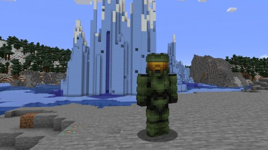 Best Minecraft skins: A Minecraft version of Master Chief stands in front of a large ice structure, bearing the recognisable green armour and helmet.