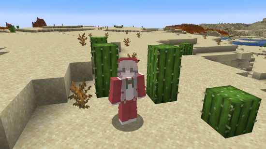Best Minecraft sins: a female player avatar stands in the desert wearing a cute red onesie, with long blonde pigtails coming out of the hood.
