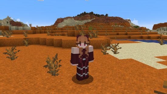 Best Minecraft skins: A red-haired player character dressed in a full scarlet witch costume stands in a badlands biome.