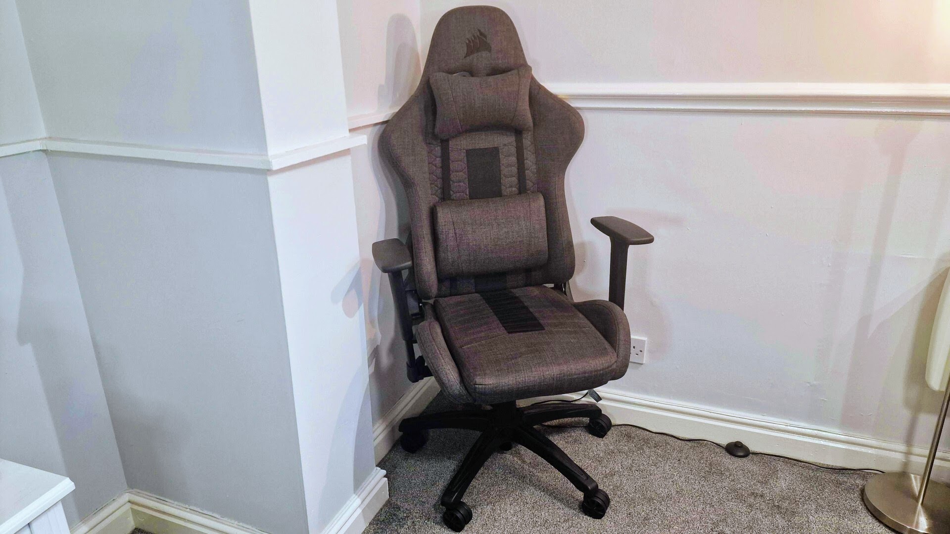 Corsair TC100 Relaxed review: A gaming chair pressed into the corner of a white room