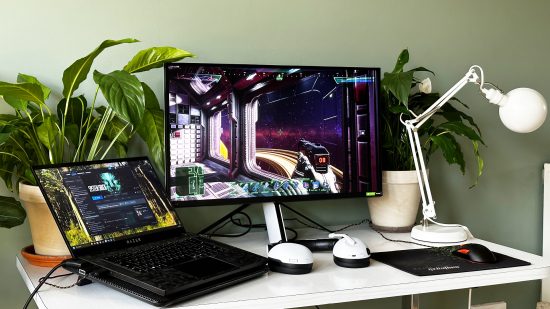 Sony Inzone M9 monitor and a gaming laptop on a desk with plants