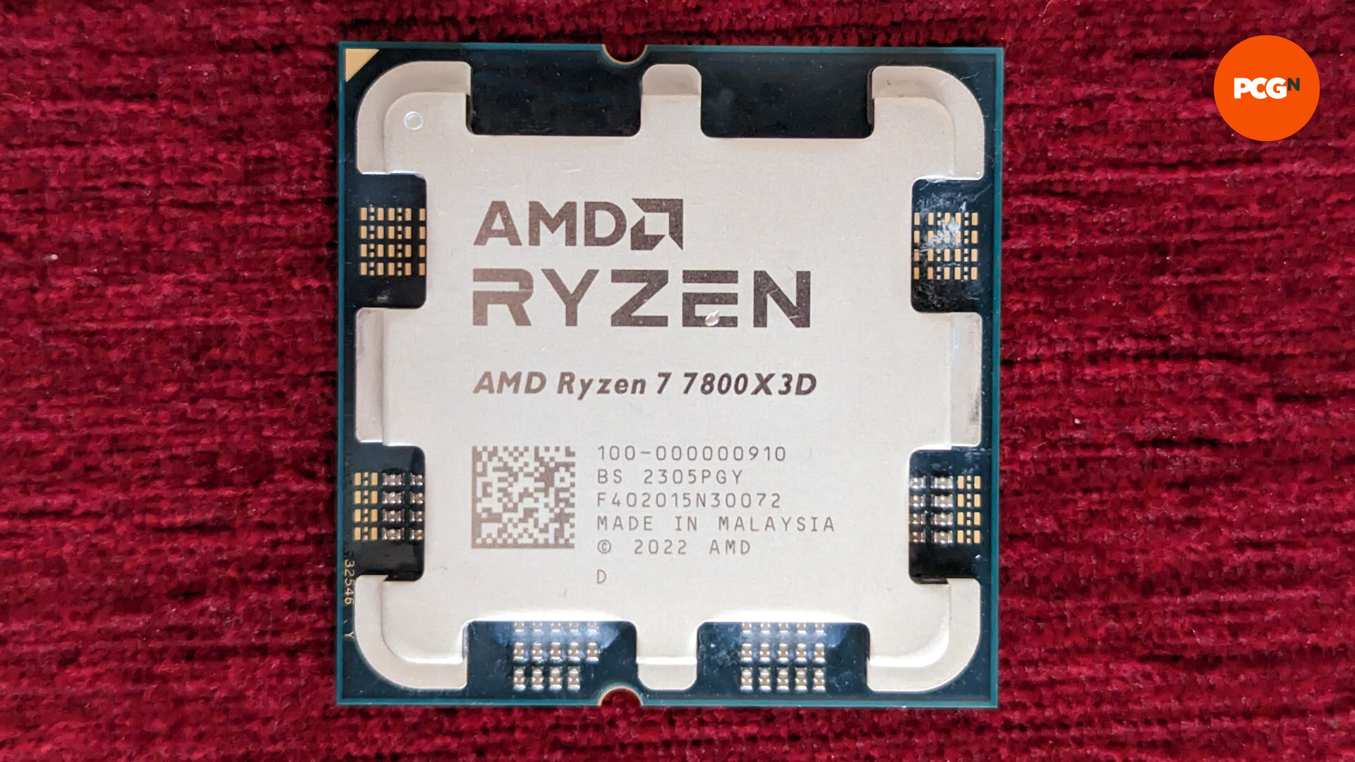 AMD Ryzen 7 7800X3D review: The CPU rests against a red surface
