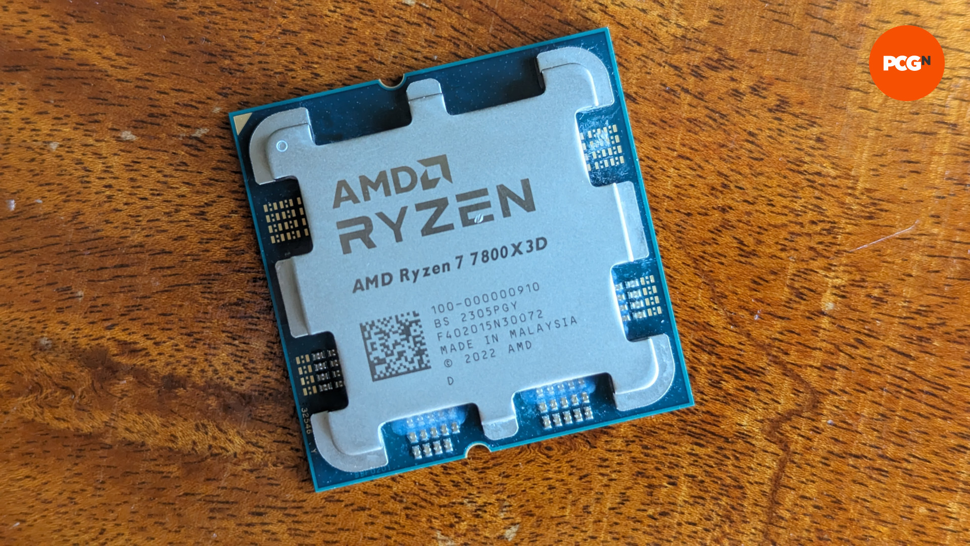 AMD Ryzen 7 7800X3D review: The CPU rests against a wooden surface