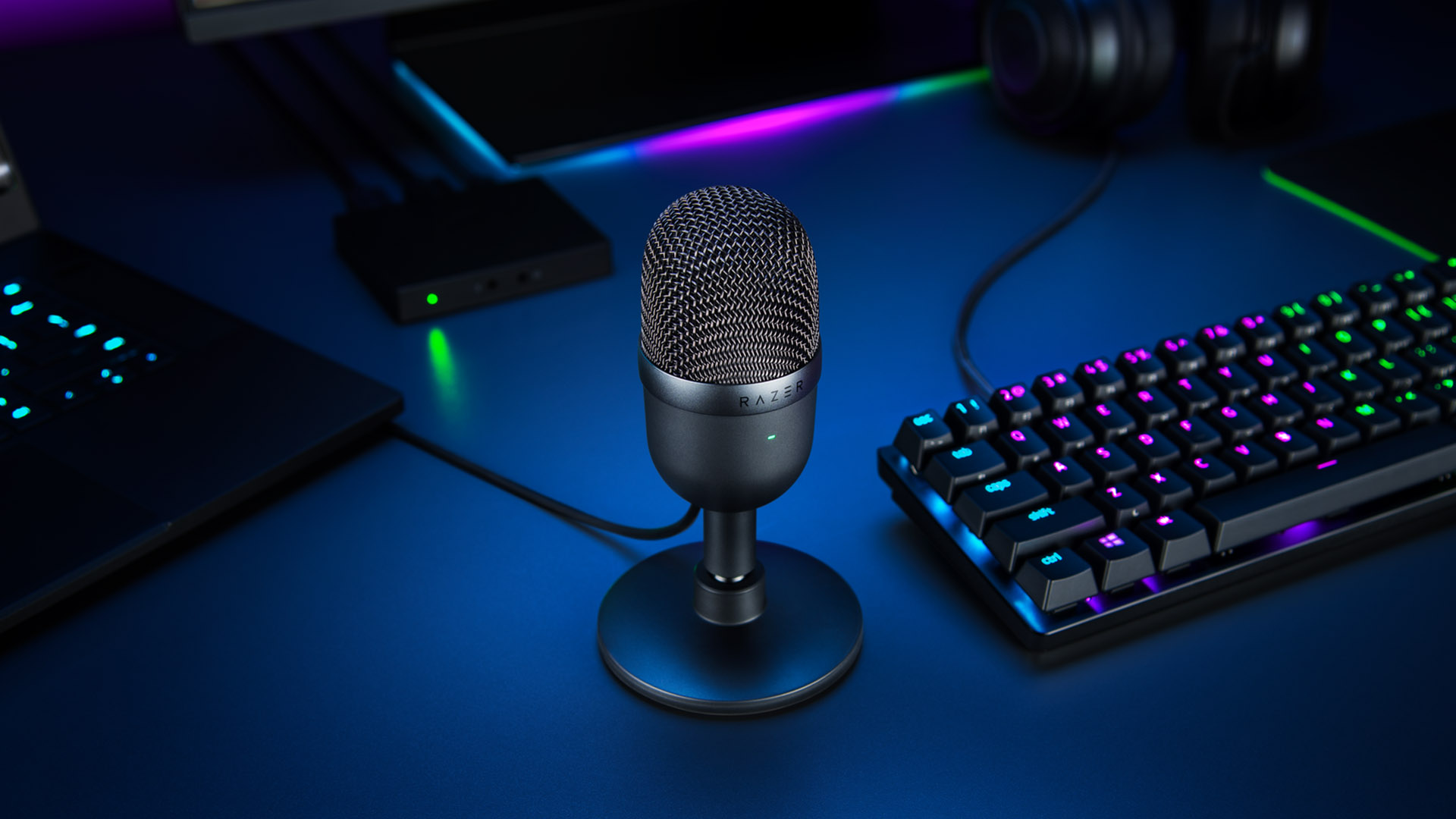 Best gaming microphone: the Razer Seiren Mini, pictured on a desk beside a keyboard.