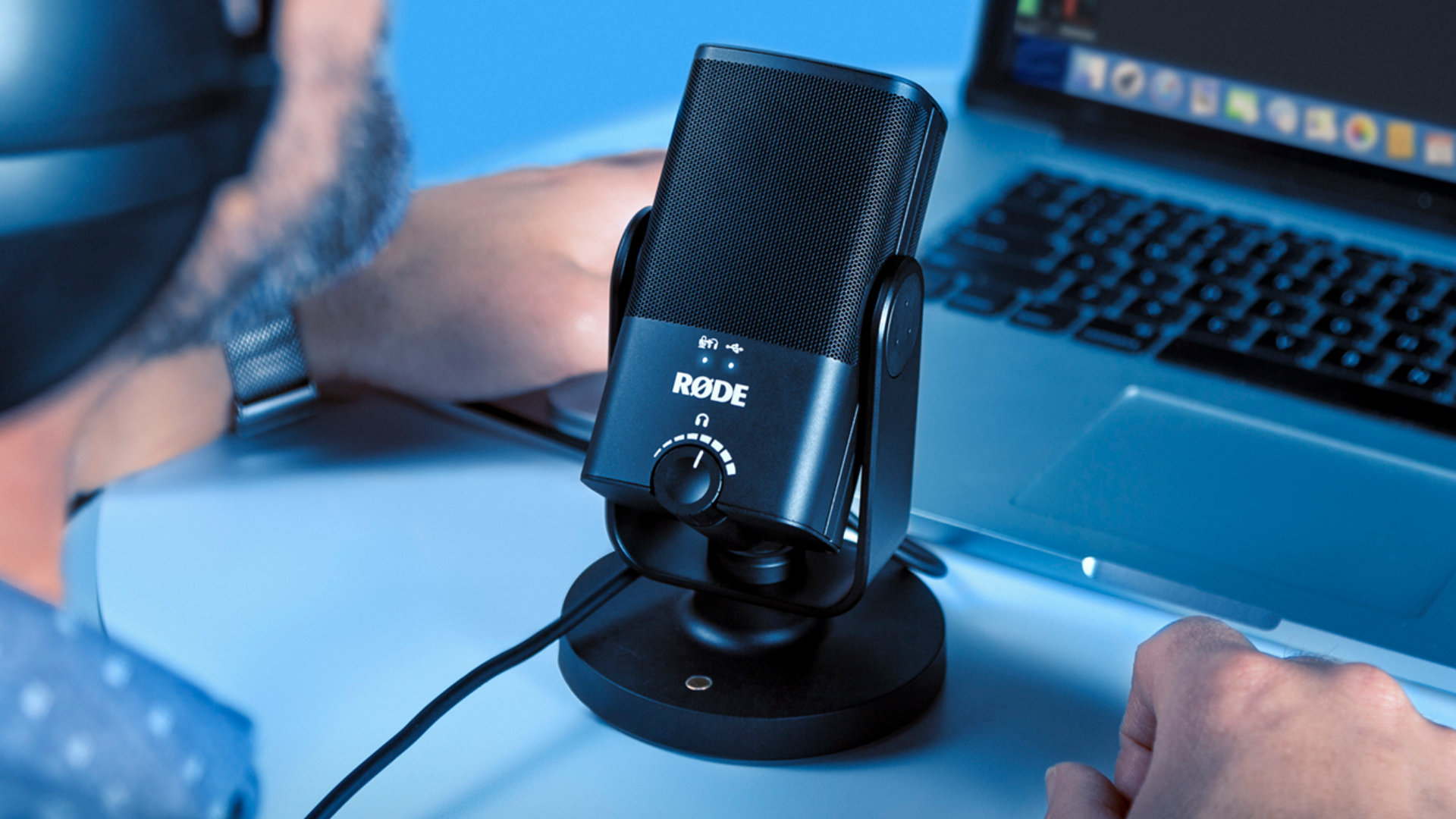 Best gaming microphone: the Rode NT-USB Mini, pictured on a desk in use by a human being.