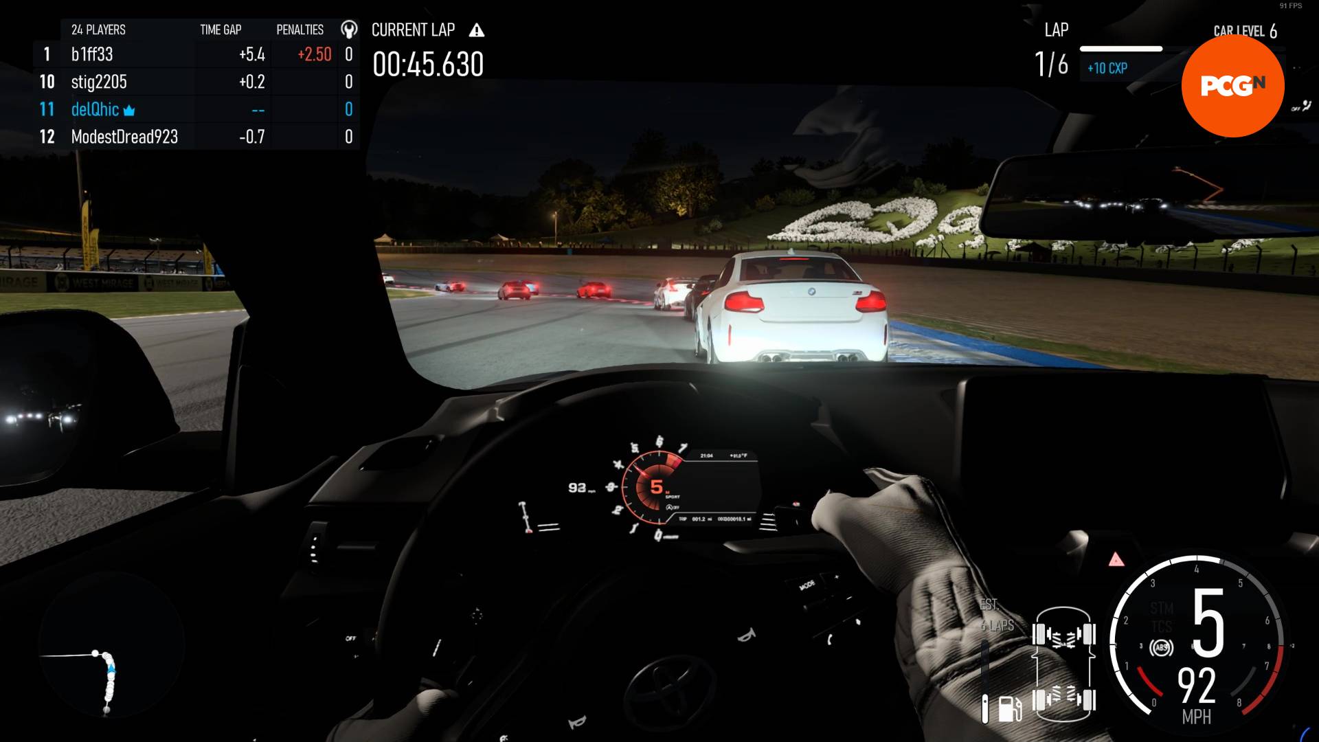 Forza Motorsport review: Driving behind the wheel at night time in 11th position behind a white BMW.