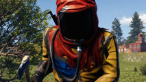 Rust console commands: a Rust player wearing a red and yellow suit, holding an axe