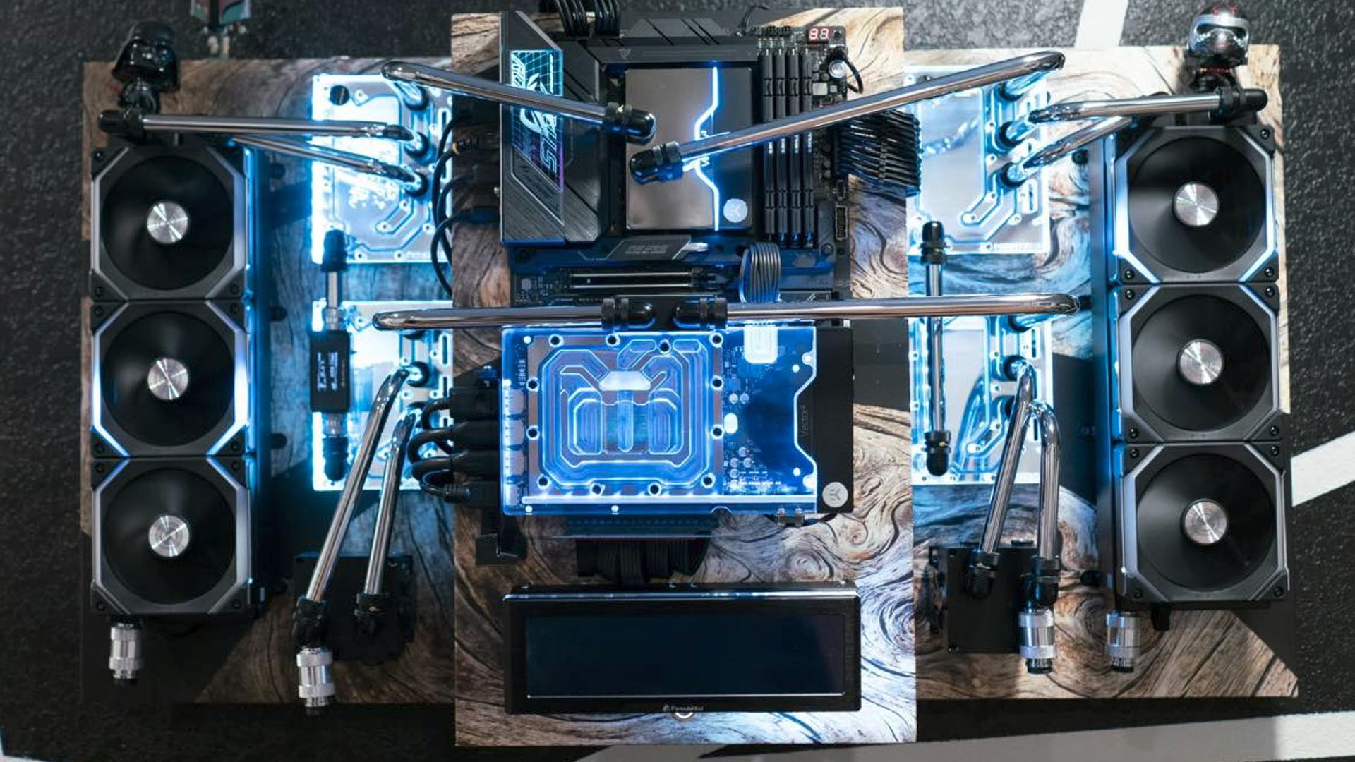 The wall mounted gaming PC with metal tubing and blue coolant