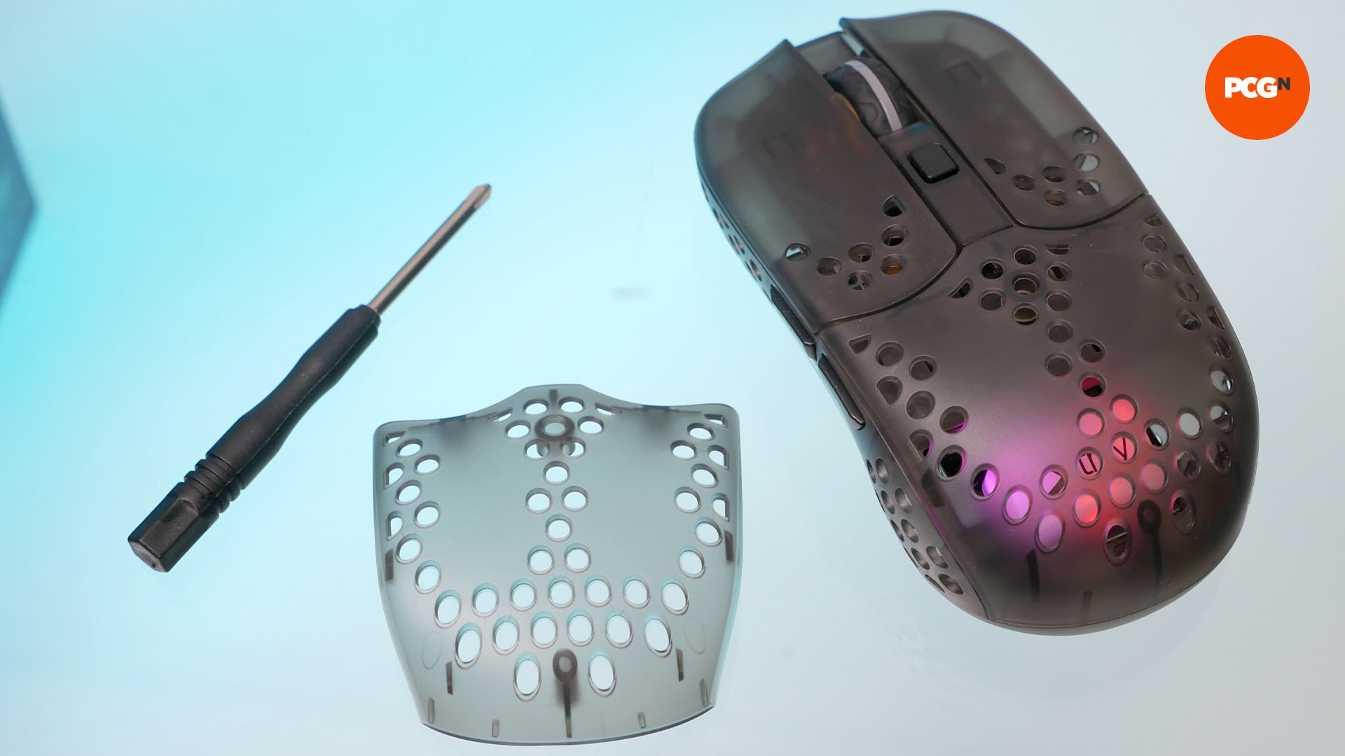A spare top plate of the cherry xtrfy MZ1 wireless mouse along with a screwdriver