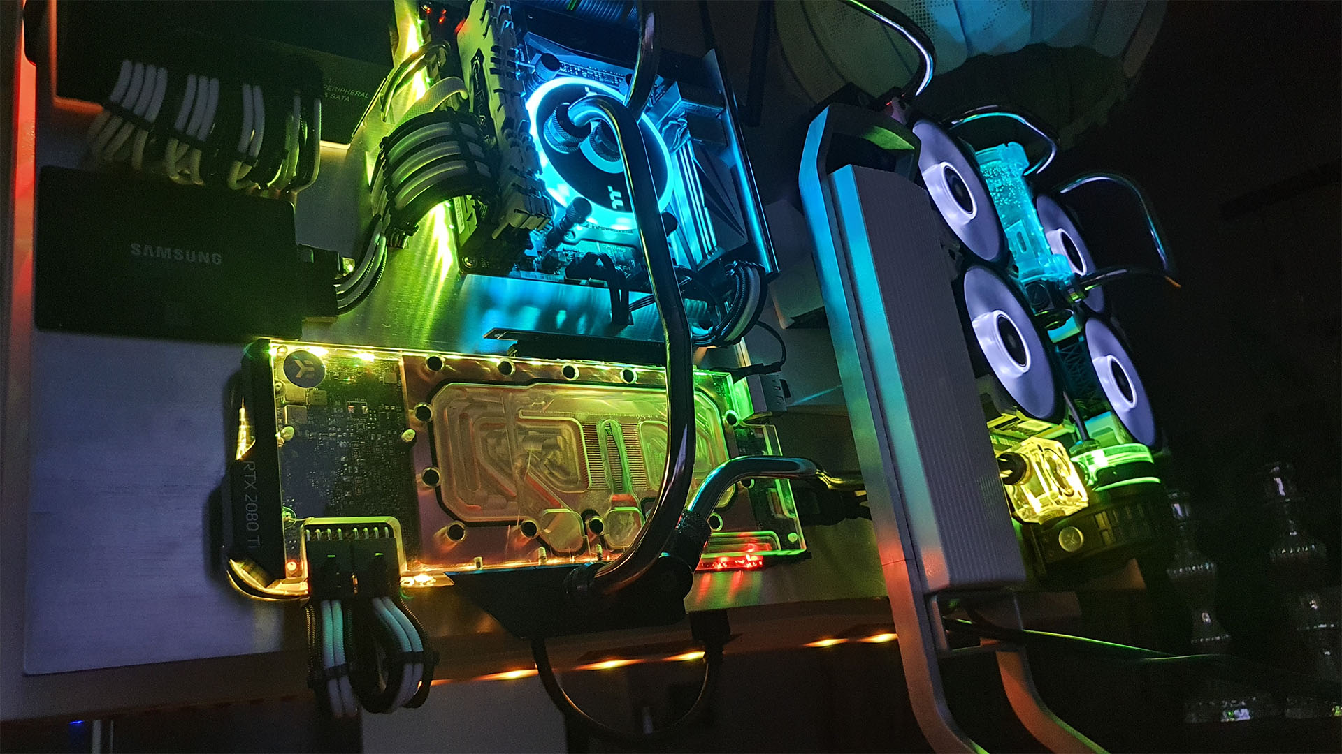 The ipredator gaming pc all lit up in blue yellow and green