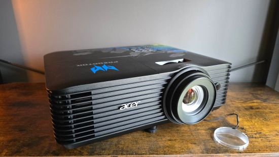 Acer Predator GM712 Projector review image showing the projector on a wooden surface.