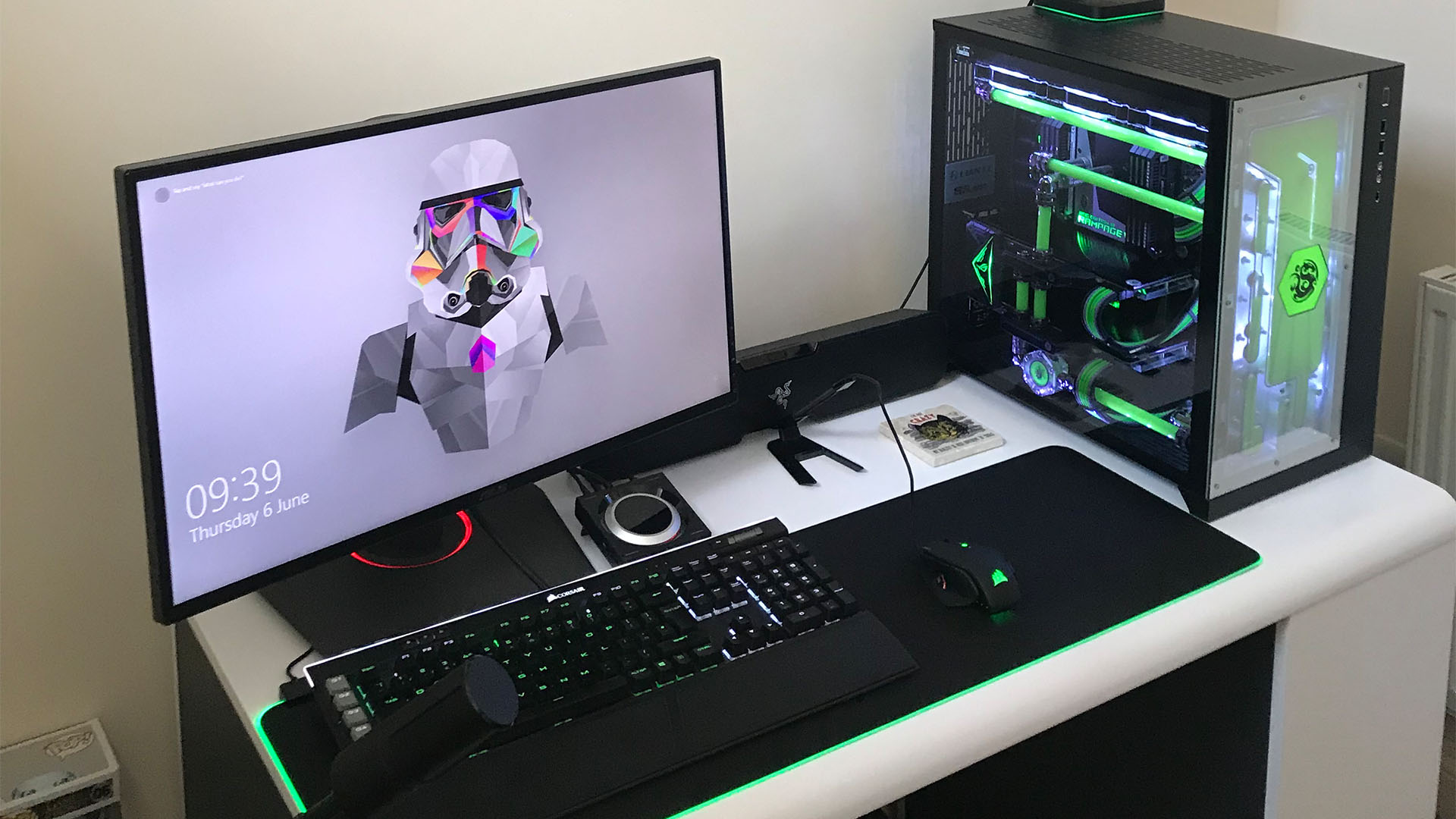 The acid rain gaming pc on a desk with a monitor mouse and keyboard