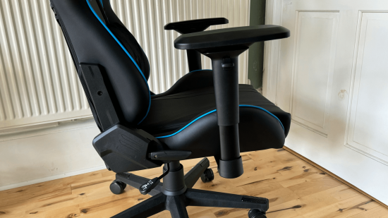 A side view of a gaming chair showing its armrests, paddles, seat and base