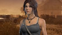 DBD and Tomb Raider collide with Lara Croft survivor you can play now: Lara Croft stands on the Rotting Fields map in DBD.