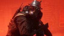 A SWAT team member wearing a gas mask and standing in front of a red background.