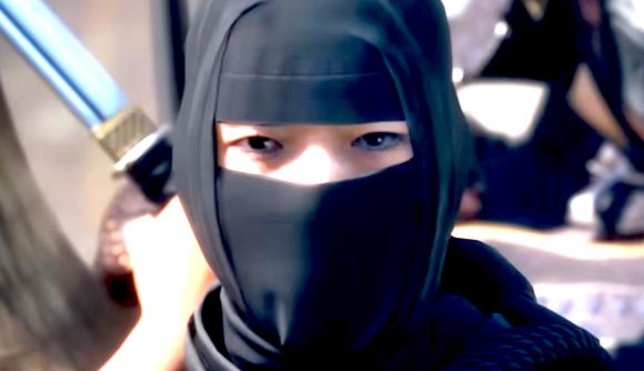 an asian woman with a dark hood and lower face covering