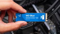 WD Blue SN5000 SSD held over motherboard
