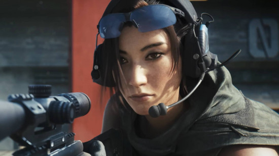 An Asian woman with combat glasses, a headset and a microphone looks off camera at a target, raising a scoped sniper rifle