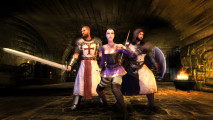 three people stand with weapons drawn in a dark dungeon