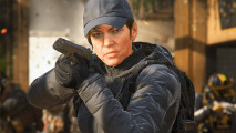 Warzone new season: Kate Laswell in riot gear and a cap, holding a pistol