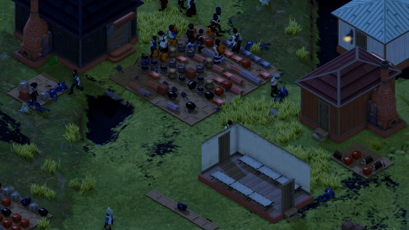 A colony at night, with a stockpile of goods in the center.